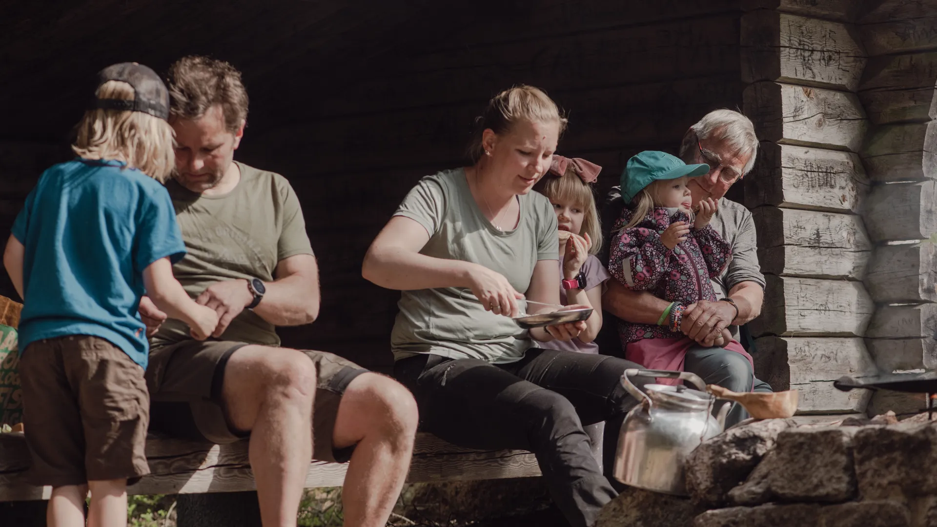 En familj sitter i vindskyddet i Högaliden.