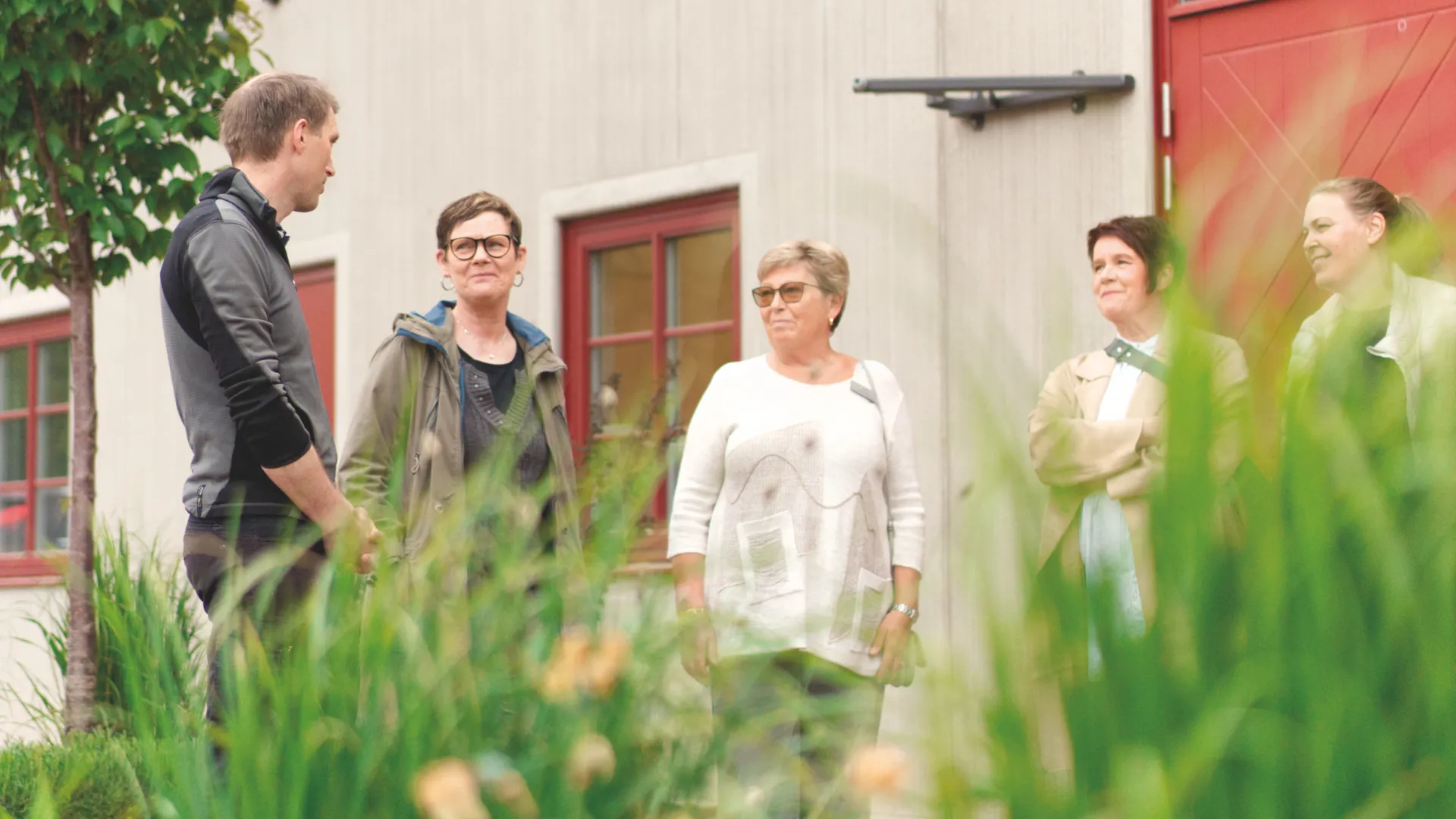 En grupp människor som står utanför en byggnad.