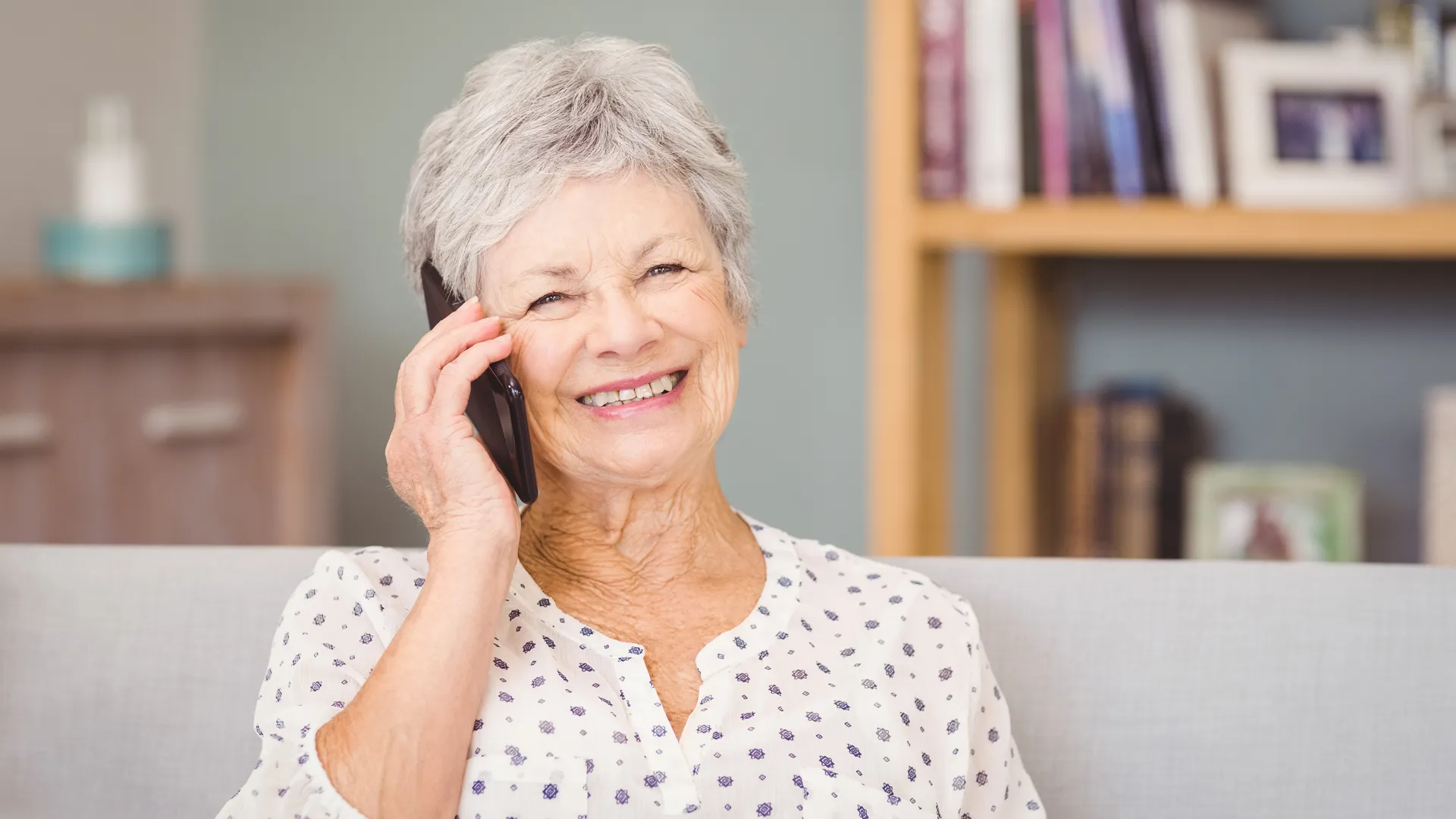 Portrait of senior woman using mobile phone at home